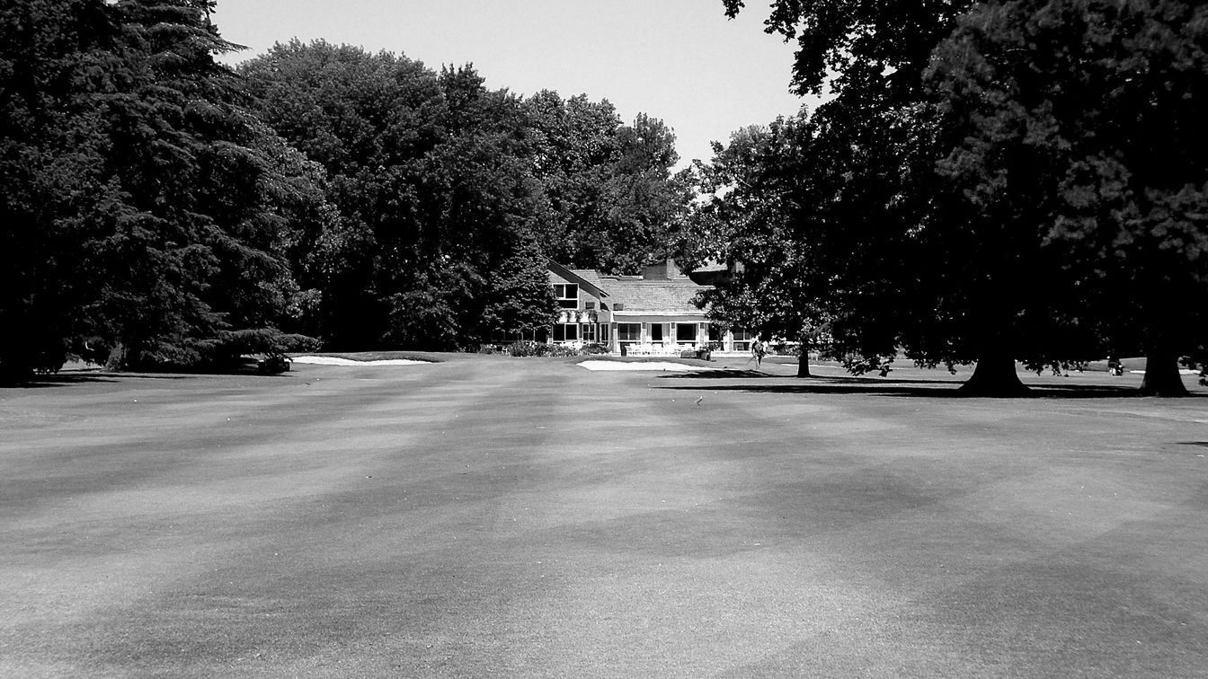 The clubhouse from the fairway, in black and white
