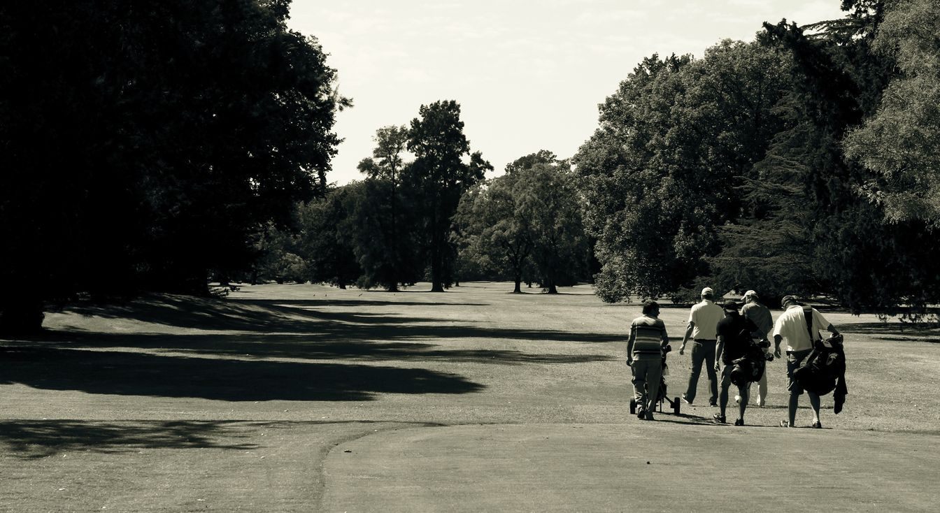 A fourball walking up the fairway