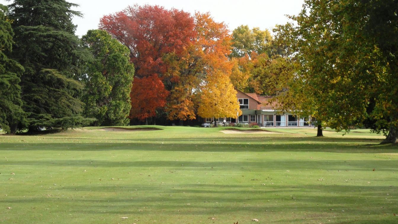 A green from behind, with the clubhouse beyond