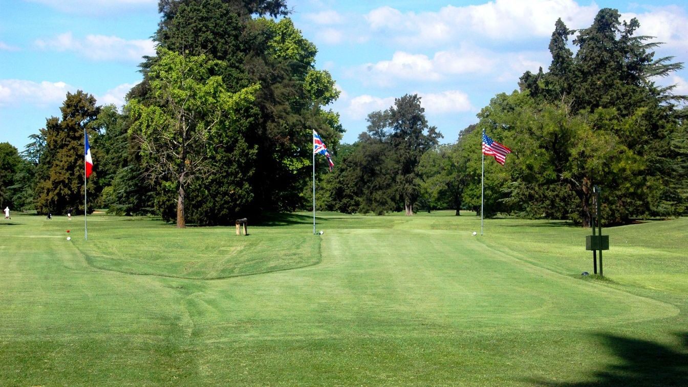 Wide parkland fairway with scattered trees